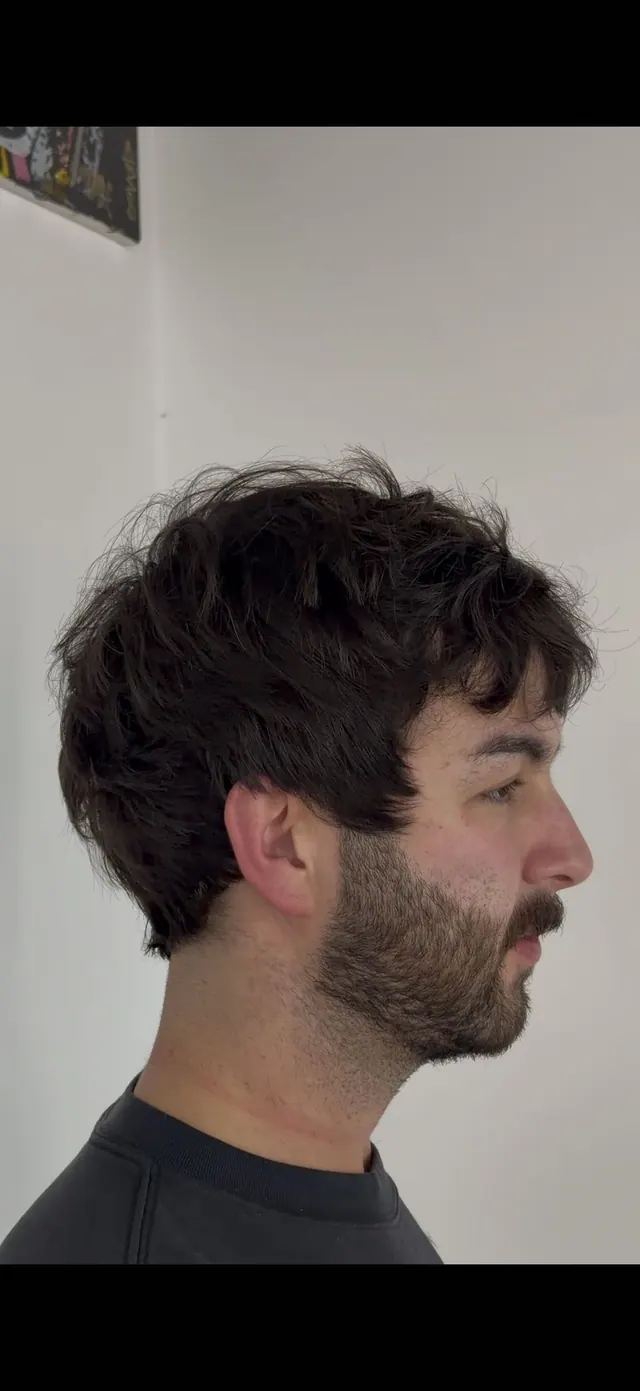 A layered scissor cut with a beard, side view