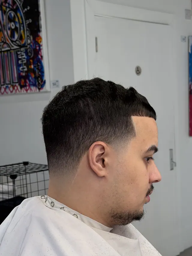 A short crop with a skin fade, side view